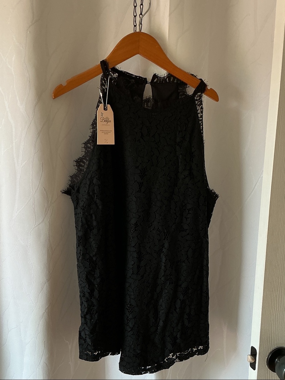 New black lace top features a sleeveless halter neckline delicate fringe trim